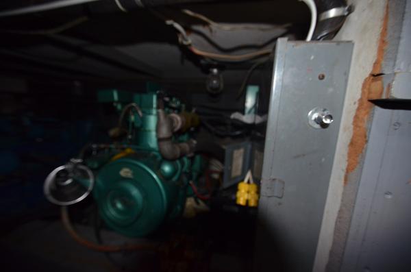 Slide: The Image of 1964 Chris-Craft Constellation engine compartment with visible wiring and machinery. - 23