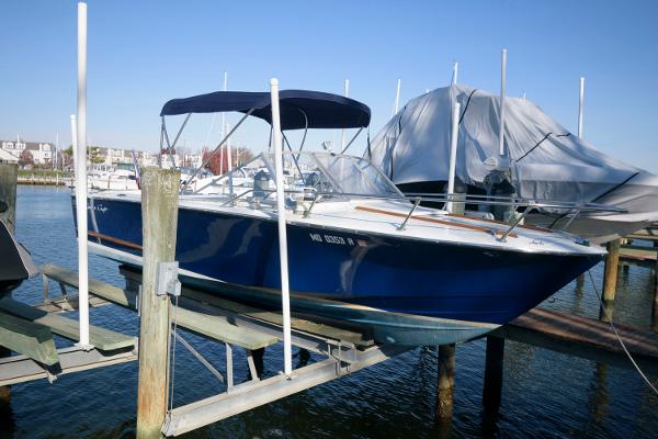 Slide: The Image of 1972 Chris-Craft Lancer 23 boat docked on a lift in a marina. - 2