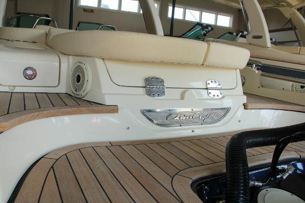 Slide: The Image of 2022 Chris-Craft Launch 25 GT interior with elegant wood finish and cushioned seating. - 16