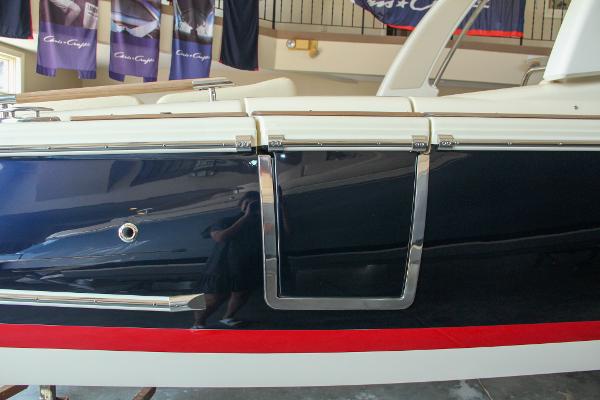 Slide: The Image of 2022 Chris-Craft Launch 25 GT boat side view with sleek design and chrome details. - 19