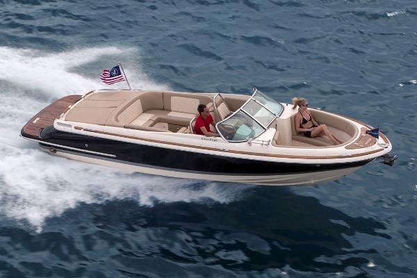 Slide: The Image of 2020 Chris-Craft Launch 27 boat cruising on open water with passengers. - 20