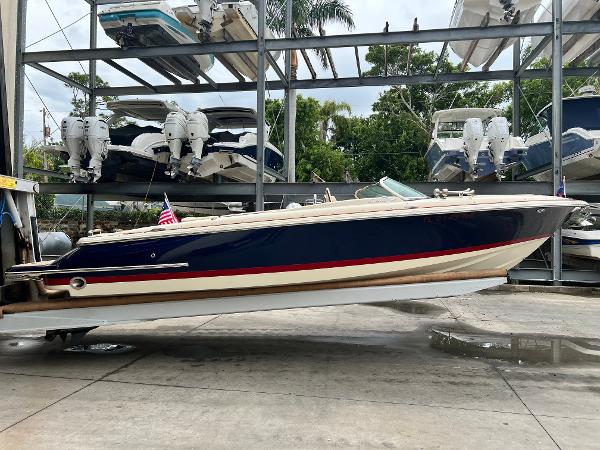 Slide: The Image of 2022 Chris-Craft Launch 27 boat in storage, side view. - 0