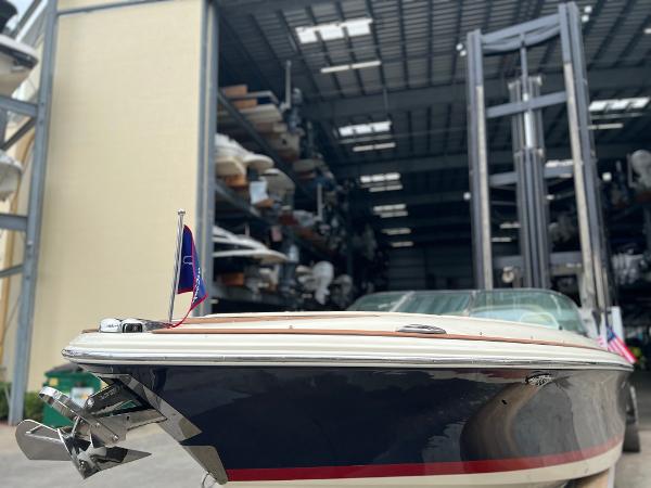 Slide: The Image of 2022 Chris-Craft Launch 27 boat docked in a storage facility. - 13
