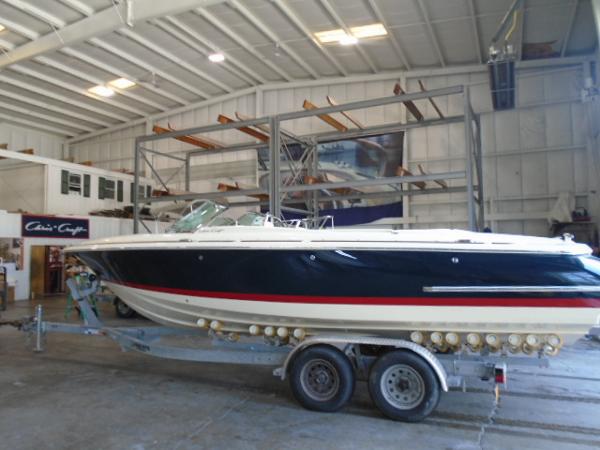 Slide: The Image of 2022 Chris-Craft Launch 27 boat on trailer in indoor storage facility. - 2