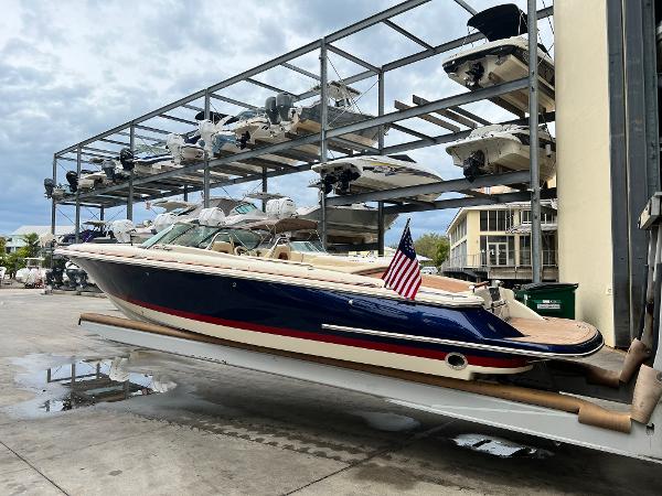 Slide: The Image of 2022 Chris-Craft Launch 27 boat in storage facility with American flag. - 7