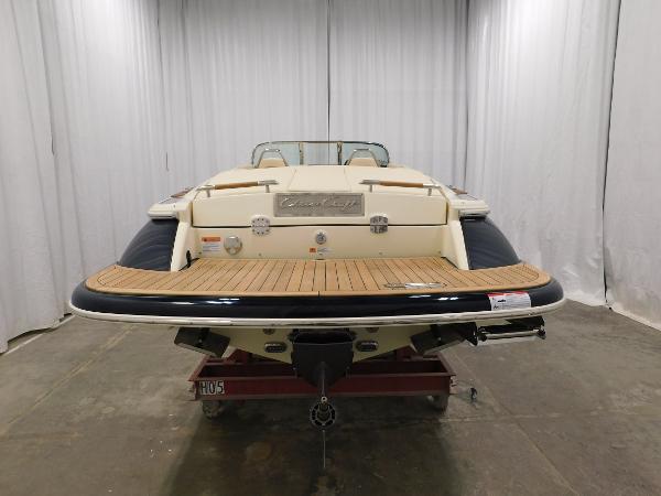 Slide: The Image of 2022 Chris-Craft Launch 27 boat, rear view in a showroom setting. - 8