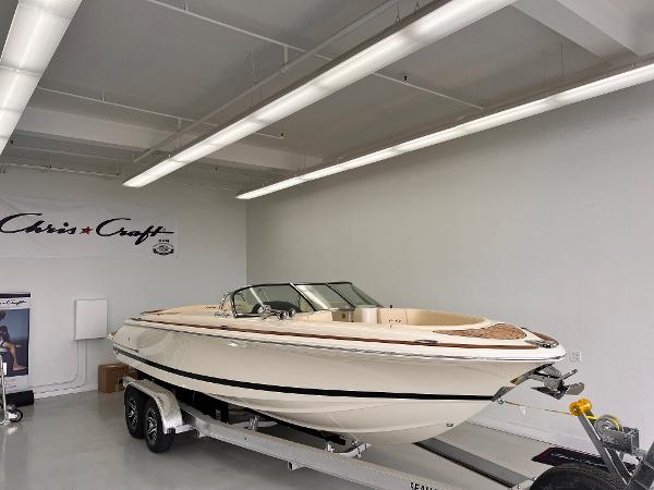 Slide: The Image of 2023 Chris-Craft Launch 27 boat on trailer in showroom. - 0