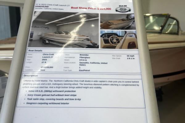 Slide: The Image of 2023 Chris-Craft Launch 27 boat details and price display at a boat show. - 12