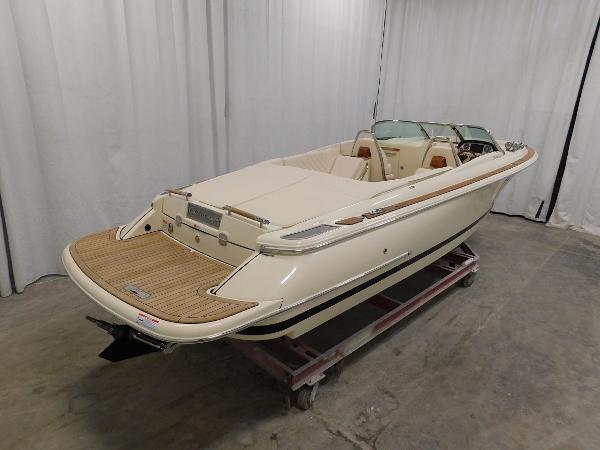Slide: The Image of 2023 Chris-Craft Launch 27 boat in showroom, rear view. - 4