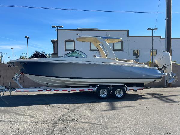 Slide: The Image of 2024 Chris-Craft Launch 28 GT boat on trailer, parked outdoors. - 0