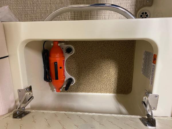 Slide: The Image of Storage compartment in 2025 Chris-Craft Launch 28 GT boat with orange device inside. - 11