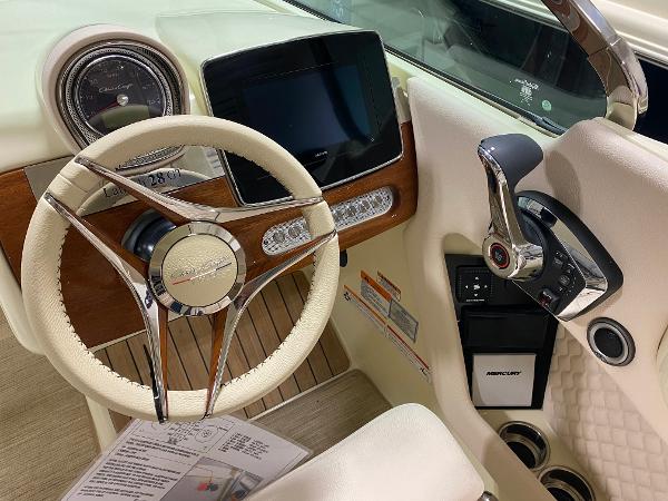 Slide: The Image of 2025 Chris-Craft Launch 28 GT dashboard with steering wheel and control panel. - 14