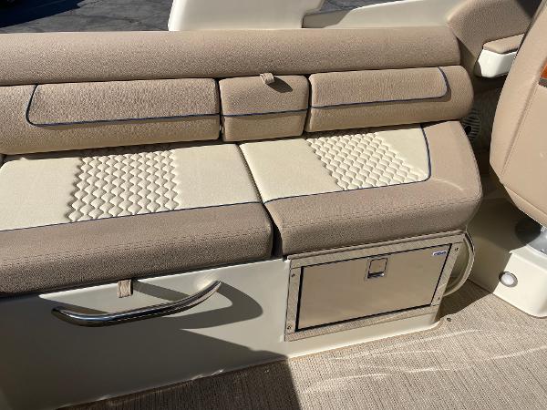 Slide: The Image of 2024 Chris-Craft Launch 28 GT interior seating with beige upholstery and storage compartment. - 15