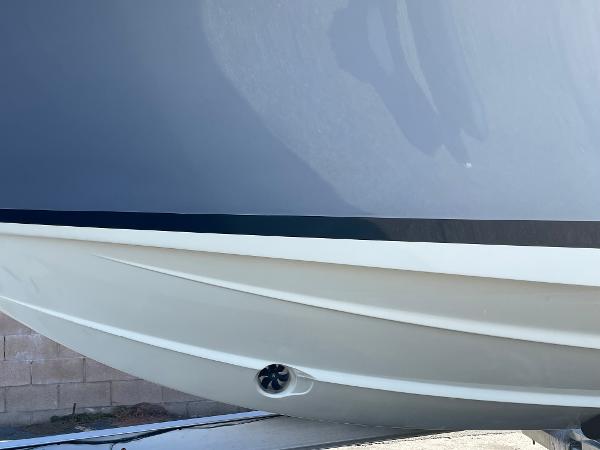 Slide: The Image of 2024 Chris-Craft Launch 28 GT boat hull close-up, sleek design. - 2