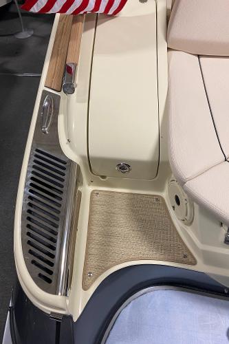 Slide: The Image of 2025 Chris-Craft Launch 28 GT boat interior with beige seating and American flag detail. - 23