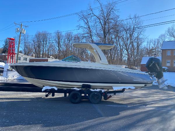 Slide: The Image of 2025 Chris-Craft Launch 28 GT boat on trailer in snowy outdoor setting. - 3