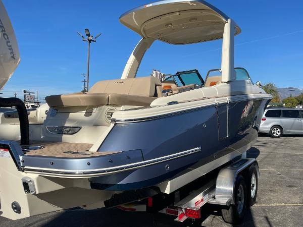 Slide: The Image of 2024 Chris-Craft Launch 28 GT boat on trailer, blue and beige exterior. - 4