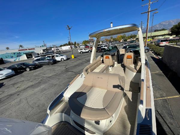 Slide: The Image of 2024 Chris-Craft Launch 28 GT boat with luxurious seating in a parking lot. - 5
