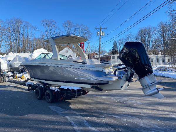 Slide: The Image of 2025 Chris-Craft Launch 28 GT boat on trailer, parked outdoors in winter setting. - 5