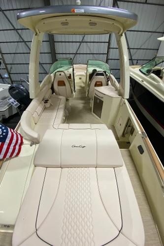 Slide: The Image of 2025 Chris-Craft Launch 28 GT boat interior with elegant seating and American flag. - 6