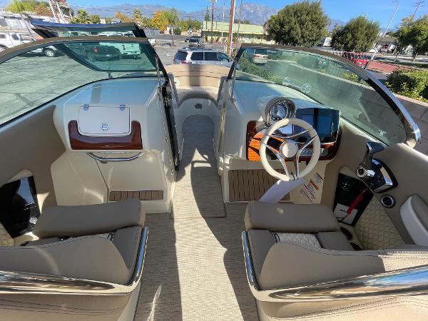 Slide: The Image of Interior view of 2024 Chris-Craft Launch 28 GT boat, featuring elegant seating and dashboard. - 9
