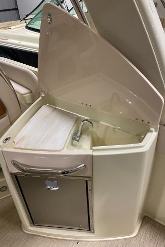Slide: The Image of 2025 Chris-Craft Launch 28 GT boat interior with sink and storage compartment. - 9