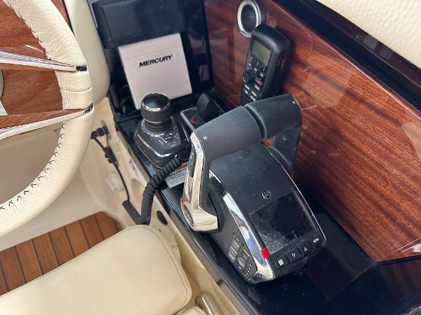 Slide: The Image of 2024 Chris-Craft Launch 31 GT boat cockpit controls and steering wheel. - 10