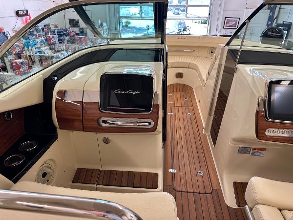 Slide: The Image of 2024 Chris-Craft Launch 31 GT interior with wood accents and modern dashboard. - 11