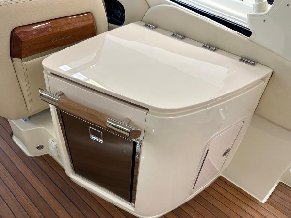 Slide: The Image of 2024 Chris-Craft Launch 31 GT interior, featuring a sleek storage compartment and elegant wood accents. - 12