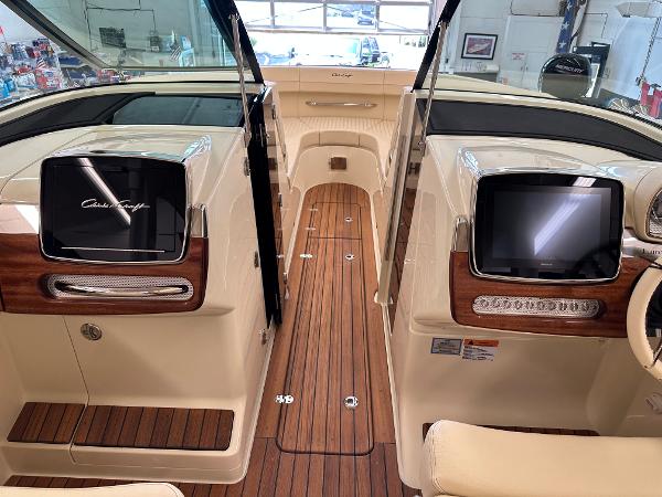 Slide: The Image of 2024 Chris-Craft Launch 31 GT interior with wood flooring and modern dashboard displays. - 14