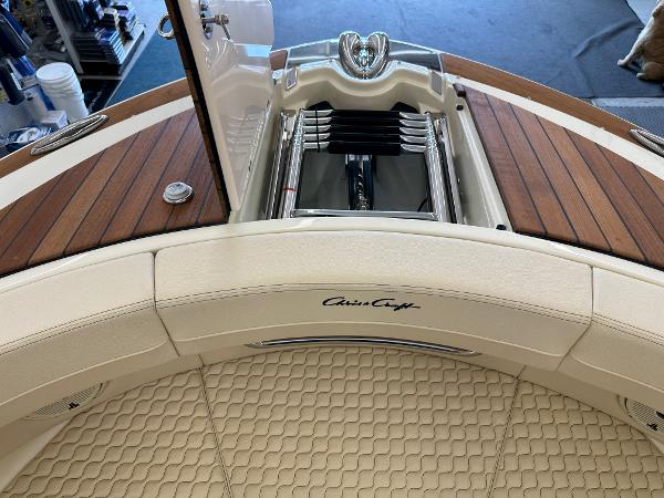 Slide: The Image of 2024 Chris-Craft Launch 31 GT boat interior with teak decking and cushioned seating. - 16