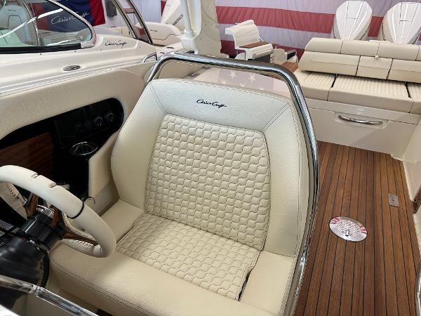 Slide: The Image of 2024 Chris-Craft Launch 31 GT boat interior with luxurious seating and wooden flooring. - 19