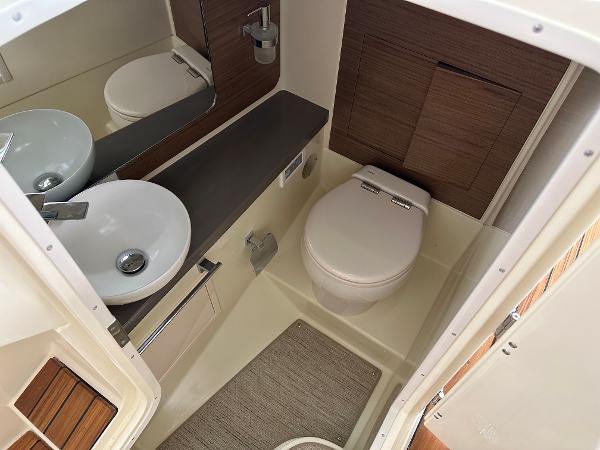 Slide: The Image of 2024 Chris-Craft Launch 31 GT boat bathroom with modern sink and toilet. - 21