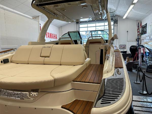 Slide: The Image of 2024 Chris-Craft Launch 31 GT luxury boat interior with beige seating and wooden accents. - 24