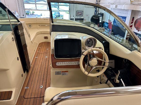 Slide: The Image of 2024 Chris-Craft Launch 31 GT boat interior with steering wheel and dashboard. - 8