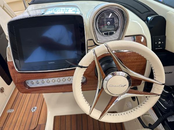Slide: The Image of 2024 Chris-Craft Launch 31 GT dashboard with Garmin display and luxury steering wheel. - 9