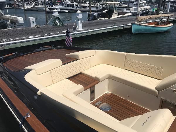 Slide: The Image of 2019 Chris-Craft Launch 34 boat with elegant seating at a marina. - 3