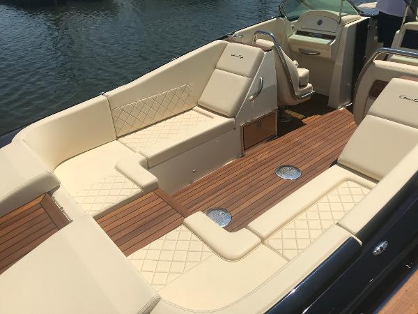 Slide: The Image of 2019 Chris-Craft Launch 34 boat interior with elegant beige seating and wooden deck. - 4
