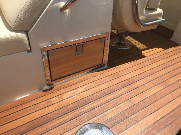 Slide: The Image of 2019 Chris-Craft Launch 34 interior with teak flooring and seating. - 6