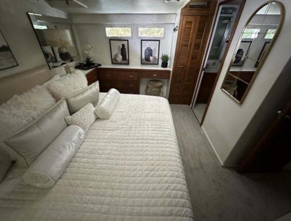 Slide: The Image of Luxurious bedroom interior of a 1976 Chris-Craft Roamer yacht with elegant decor. - 46