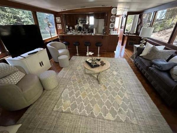 Slide: The Image of Luxurious interior of a 1976 Chris-Craft Roamer yacht with modern furnishings and large windows. - 9