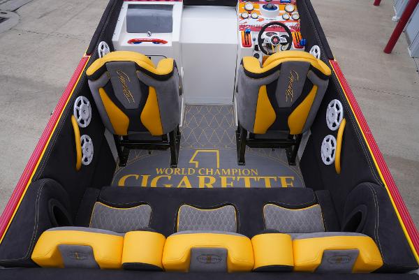 Slide: The Image of 2005 Cigarette 38 Top Gun boat interior with yellow and black seats, steering wheel, and dashboard. - 13