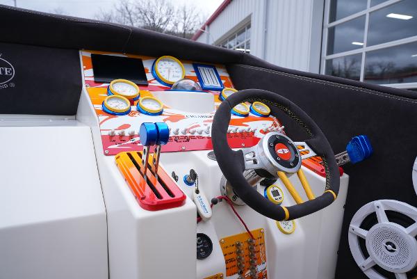 Slide: The Image of 2005 Cigarette 38 Top Gun boat dashboard with steering wheel and control gauges. - 21