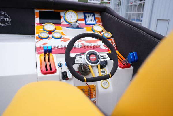 Slide: The Image of Cockpit of a 2005 Cigarette 38 Top Gun boat with vibrant controls and gauges. - 22