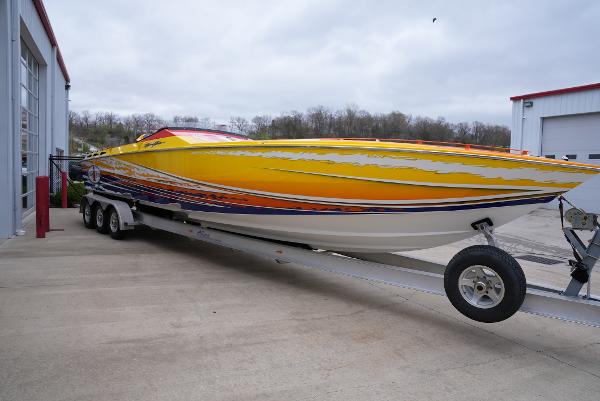 Slide: The Image of 2005 Cigarette 38 Top Gun speedboat on a trailer outside a garage. - 3