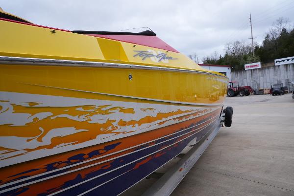 Slide: The Image of 2005 Cigarette 38 Top Gun boat with vibrant yellow and orange graphics. - 4