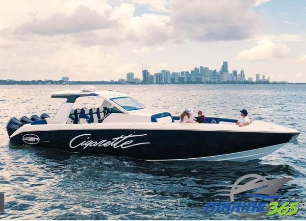 Slide: The Image of 2024 Cigarette 41 Nighthawk boat cruising on water with city skyline in background. - 0