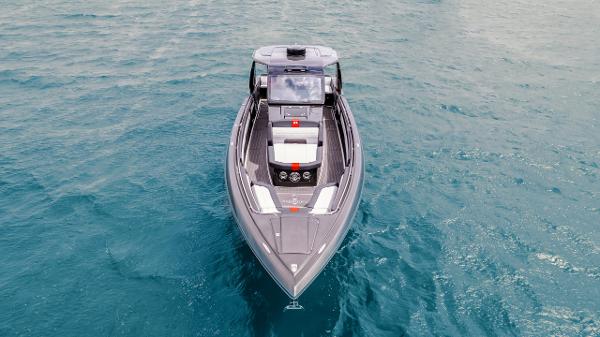 Slide: The Image of 2025 Cigarette 41 Nighthawk boat cruising on clear blue water. - 10