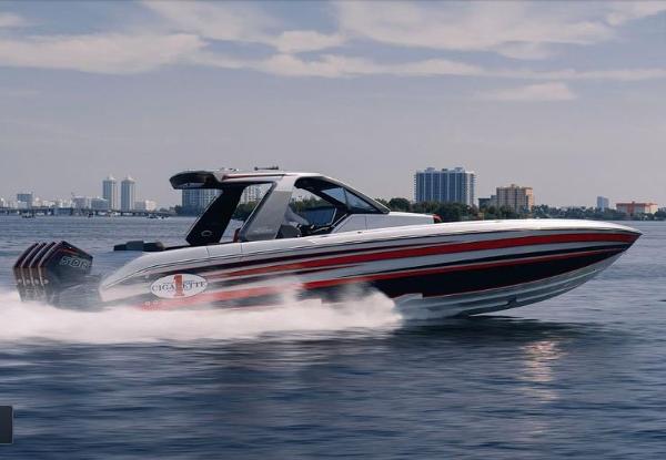 Slide: The Image of 2024 Cigarette 41 Nighthawk speedboat cruising on water with city skyline in background. - 4