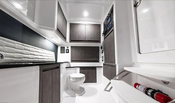 Slide: The Image of 2024 Cigarette 41 Nighthawk boat interior with modern bathroom and storage cabinets. - 7